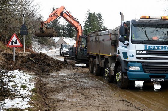 Moray Council roadworkers clearing up the landslip