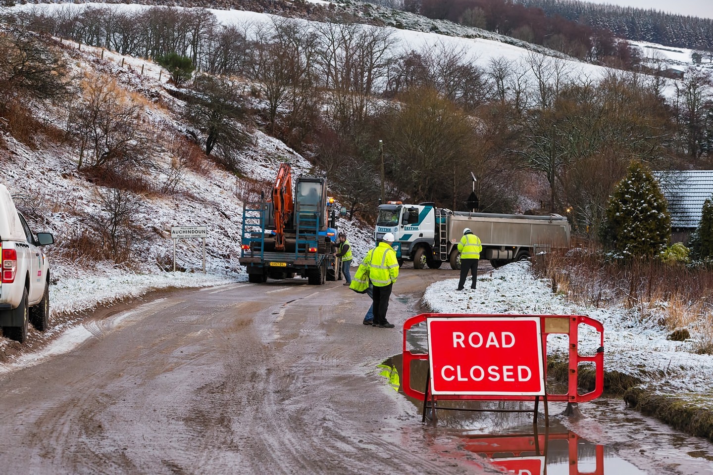 Moray Council roadworkers clearing up the landslip 