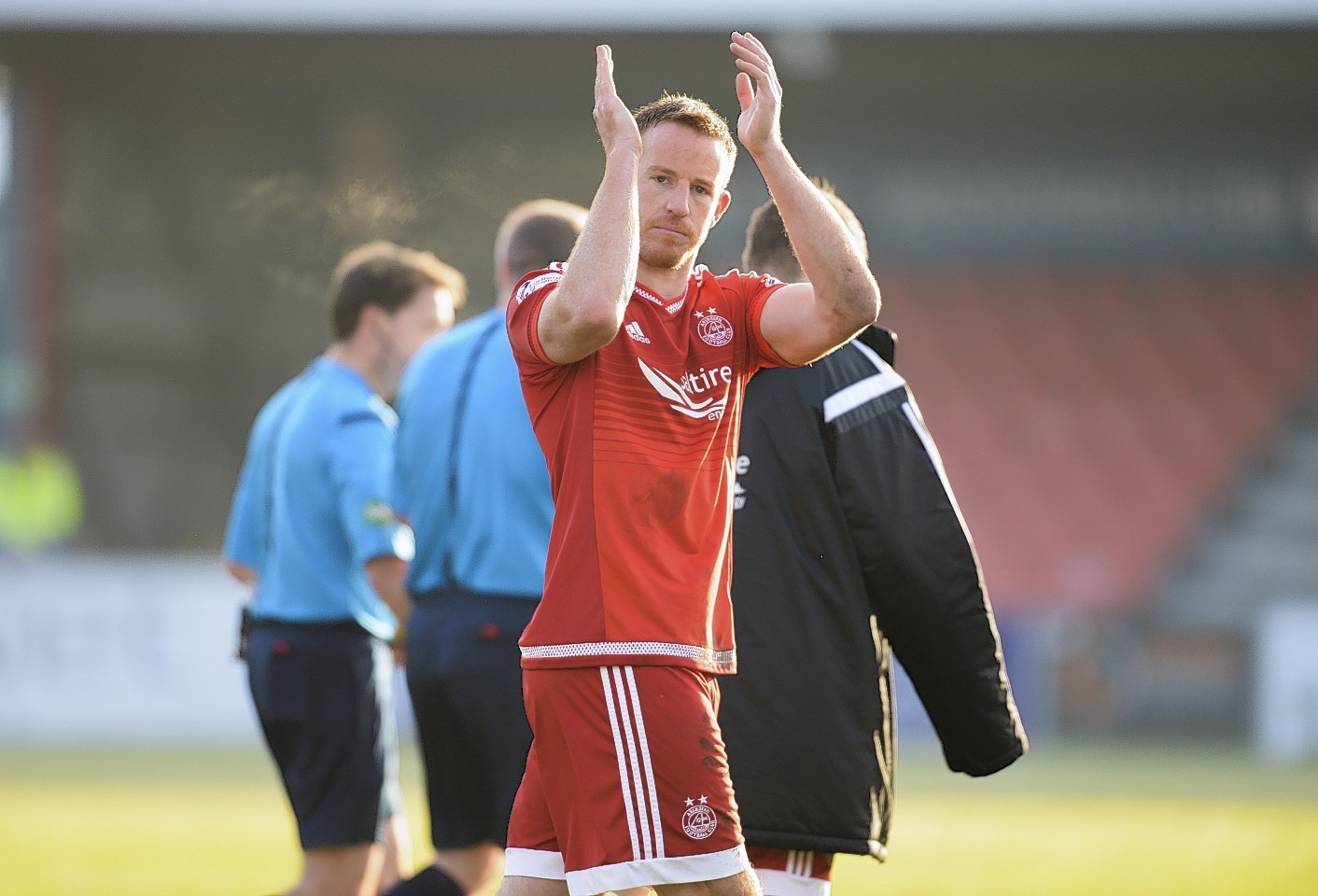 Adam Rooney applauds fans at full time in Dingwall