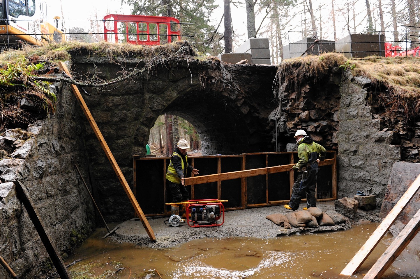 Aberdeenshire Council working to repair the Invercauld Bridge near Braemar, following the devastating floods of the past week. Picture by Kenny Elrick