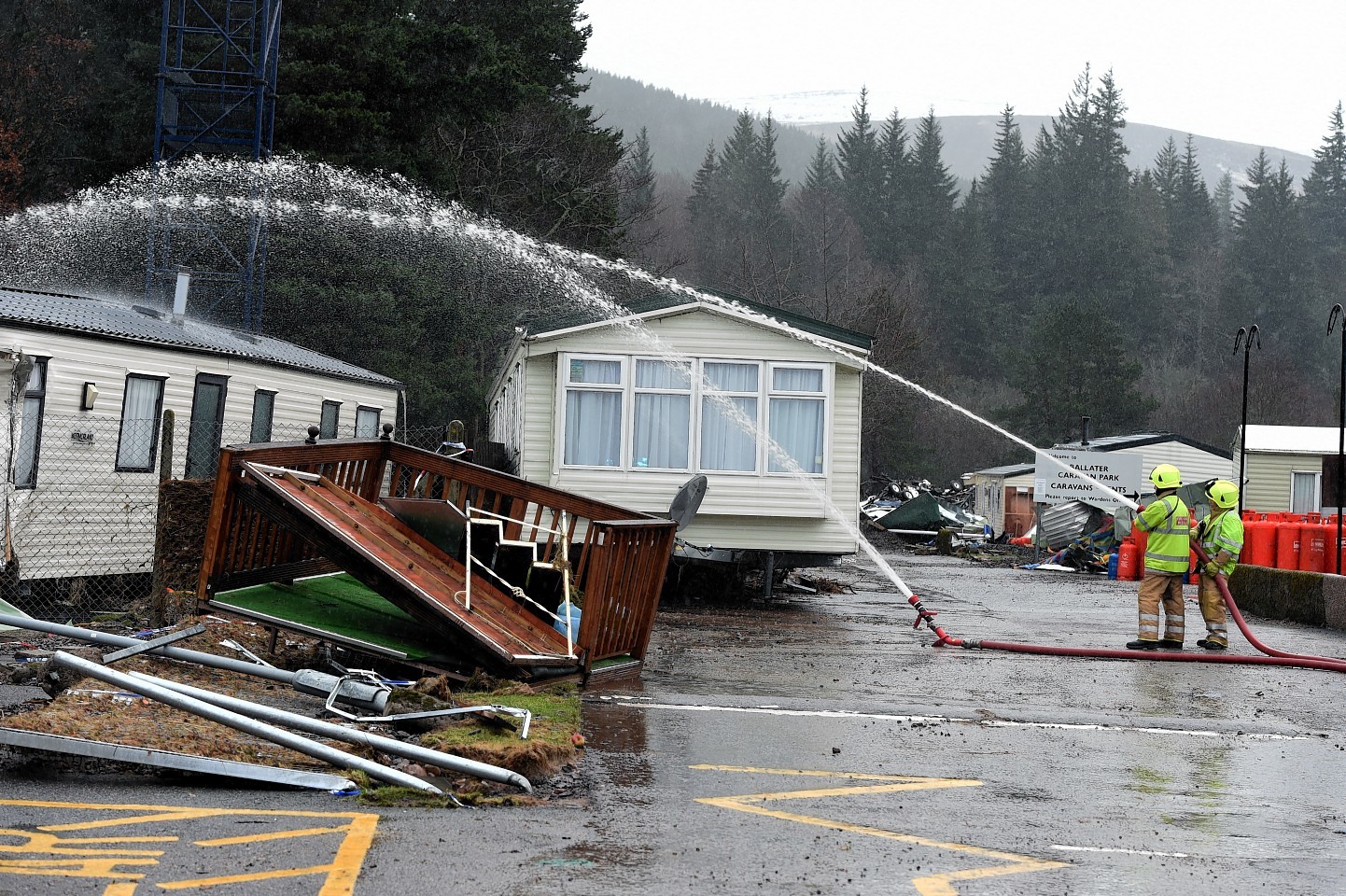 Flooding in Ballater. Fire fighters try to unblock the drains at the caravan park. Picture by Jim Irvine