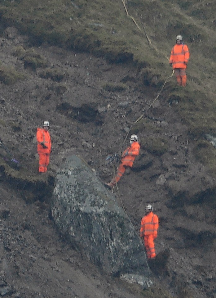 Workmen prepare to detonate the huge boulder above the Rest and be Thankful pass near Arrochar