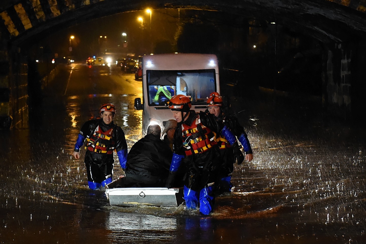 Fire crews rescue people from a bus left stranded in the floods earlier today on Stoneywood Road in Dyce. Picture by Kenny Elrick