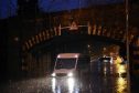 A bus trapped by the floods on Stoneywood Road in Dyce. Pictures by Kenny Elrick