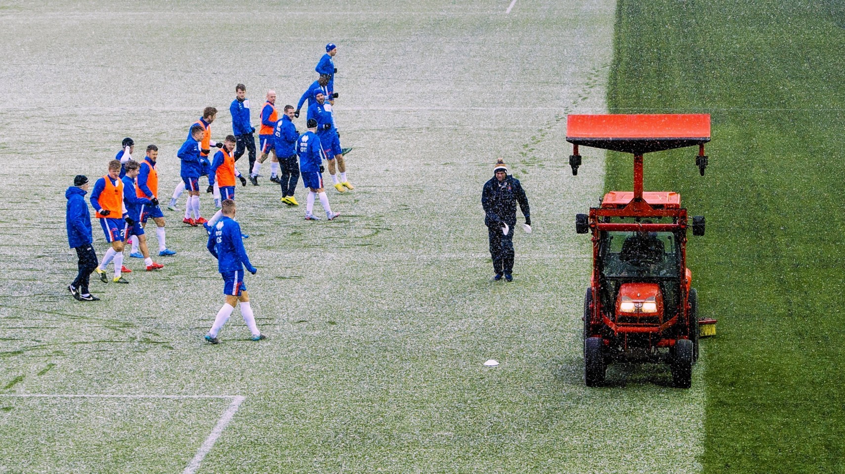 The Kilmarnock groundsmen try to clear the pitch.