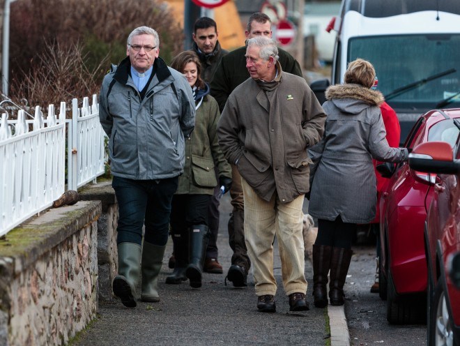 Prince Charles speaks to residents in Ballater earlier this year amongst the devastation in the wake of Storm Frank