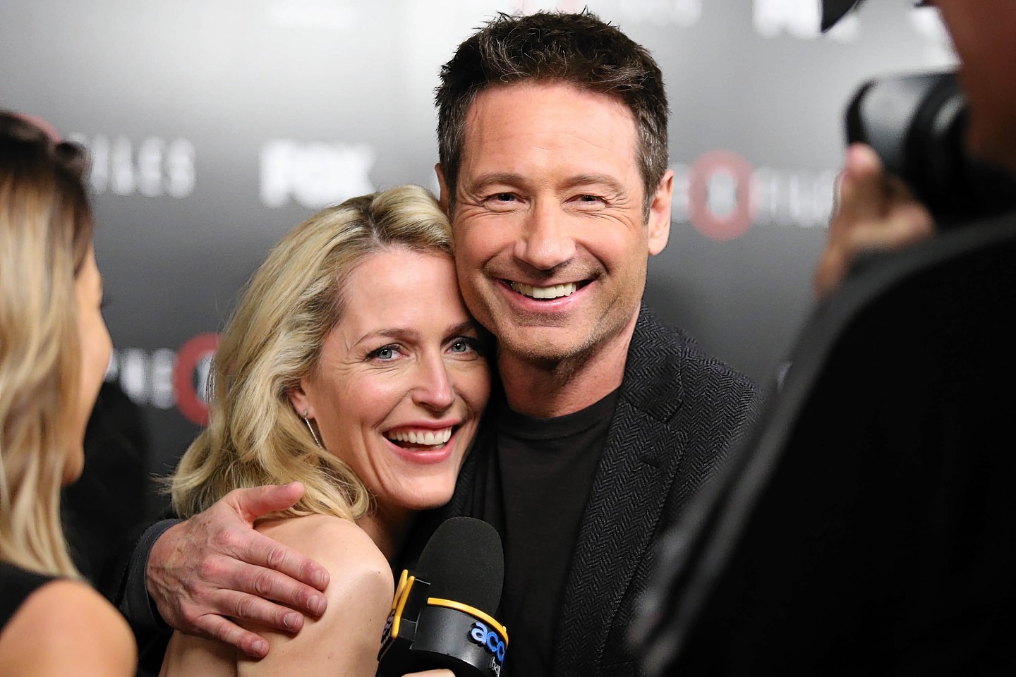 Gillian Anderson and David Duchovny share a laugh during an interview at the season premiere of 'The X-Files