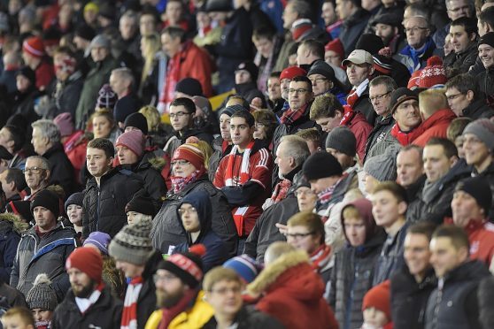 The Red Army take in the action at Pittodrie.