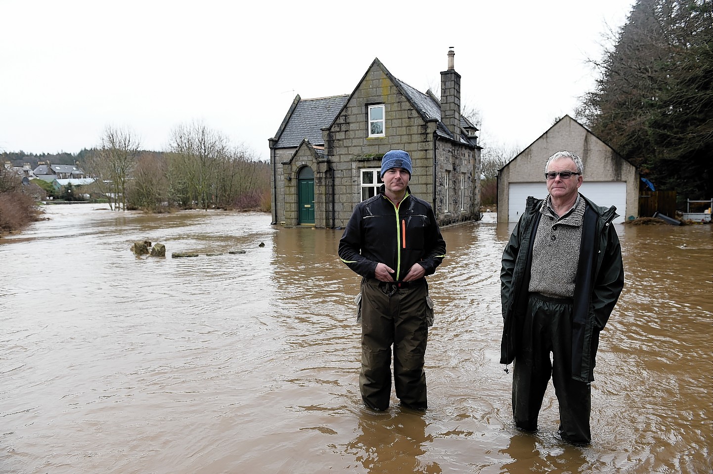 The River Ythan has burst it's banks at Ellon.  
The home of George Thomson on the banks of the Ythan near the old bridge which was flooded last night.
George (right) is pictured with his son Craig Thomson.    
  
Picture by Kami Thomson    08-01-15