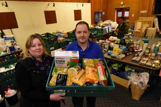 Fiona Conner and co-organiser George Petrie of the Flood Support group, have been collecting donations to give to flood victims at the British Legion, Inverurie. Picture by Kenny Elrick