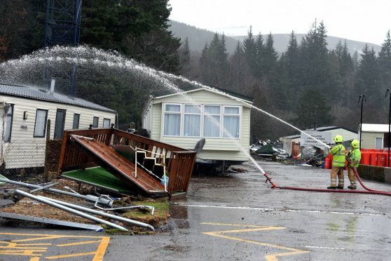 Flooding in Ballater. Fire fighters try to unblock the drains at the caravan park. Picture by Jim Irvine