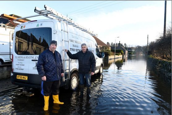 Flooding in Kintore: Local residents, Brian Fowler, left and John Thomson at Kingsfield Road, Kintore. Picture by Jim Irvine