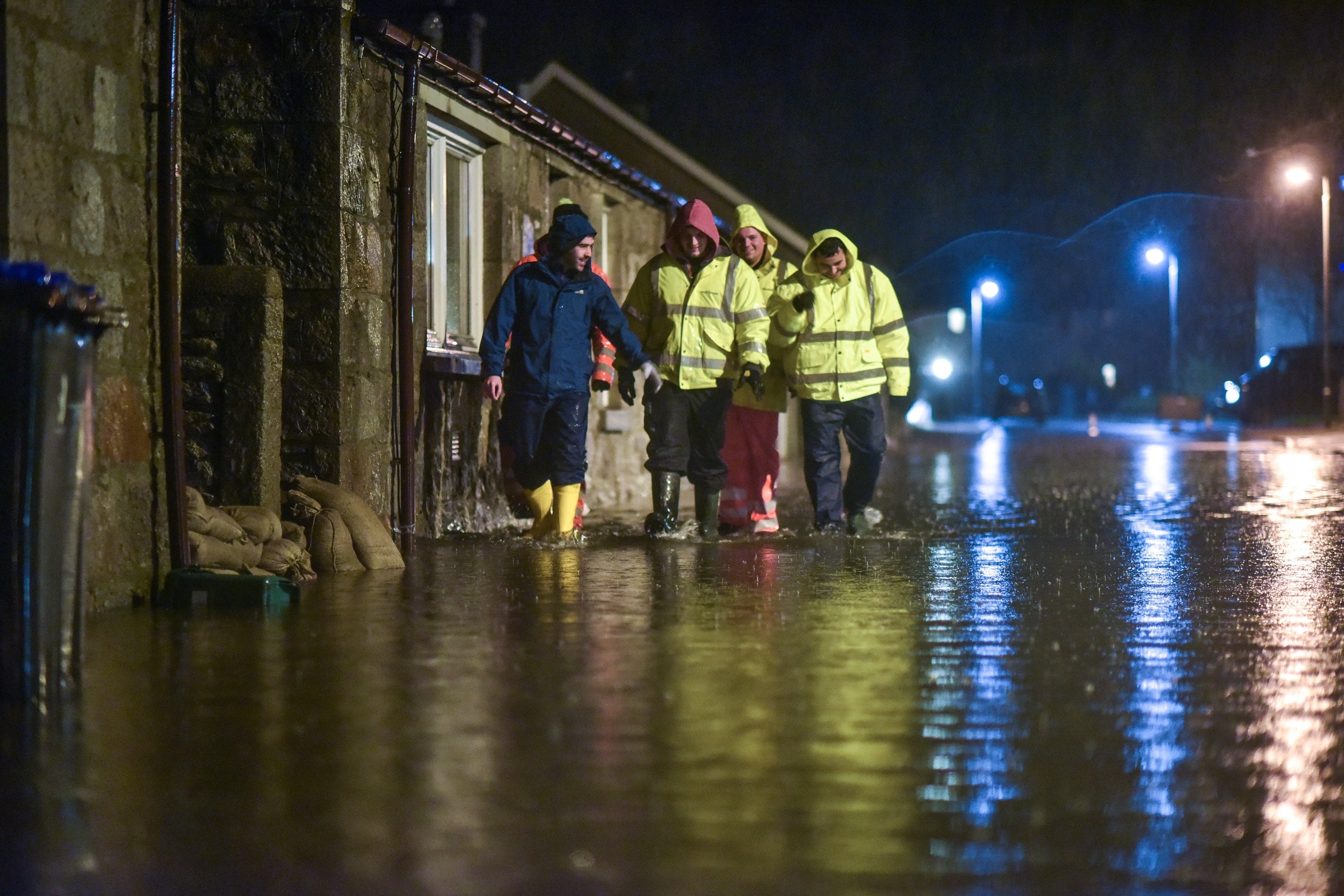 Men search homes in the Port Elphinstone area of Inverurie, Aberdeenshire as they begin to experience flooding after the River Don burst its banks on January 07 2016. Scottish Envornmental Protection Agency (SEPA) have issued two severe flood warnings for both Inverurie and Kintore, both in Aberdeenshire.