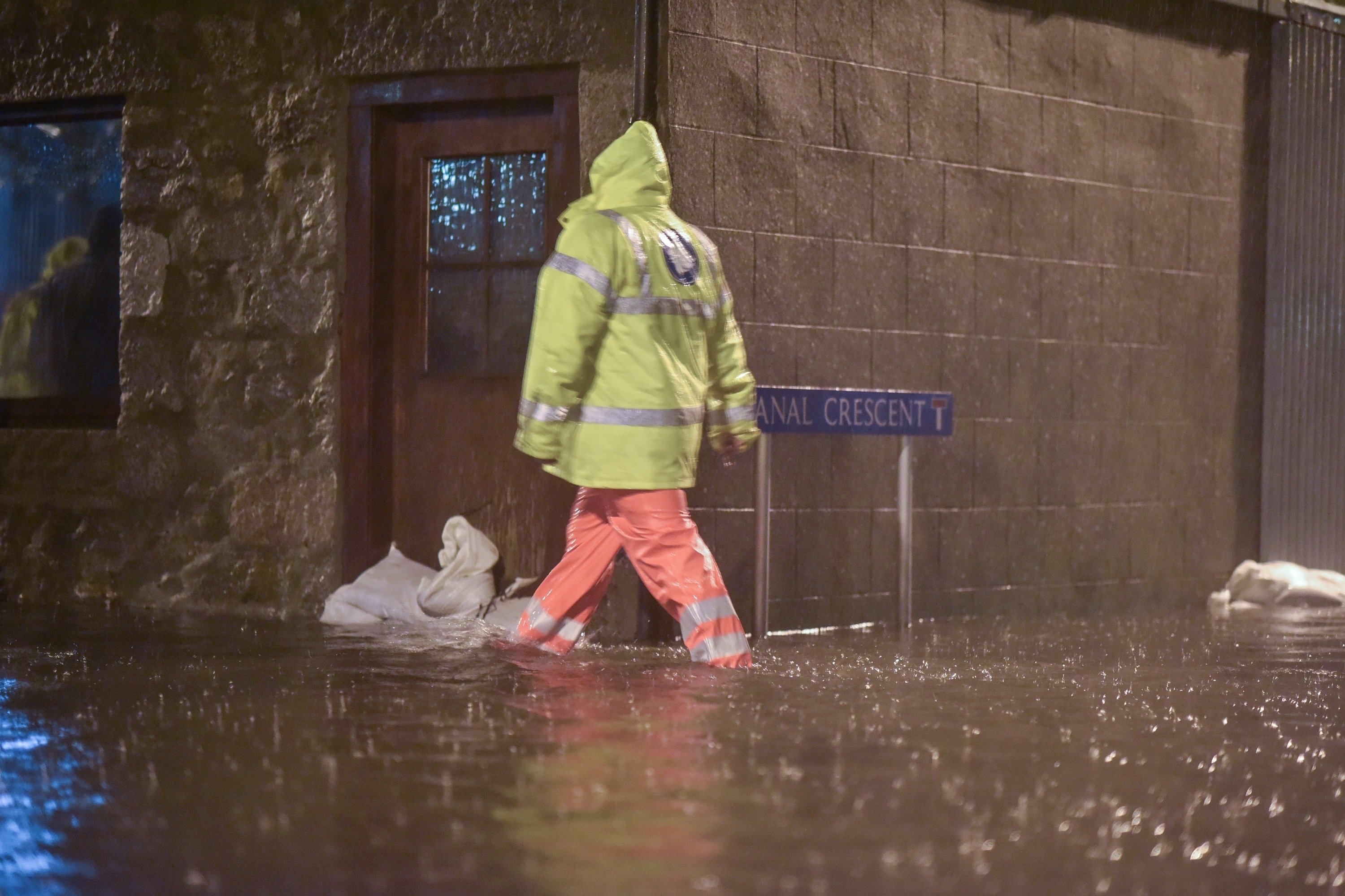 Men search homes in the Port Elphinstone area of Inverurie, Aberdeenshire as they begin to experience flooding after the River Don burst its banks on January 07 2016. Scottish Envornmental Protection Agency (SEPA) have issued two severe flood warnings for both Inverurie and Kintore, both in Aberdeenshire.