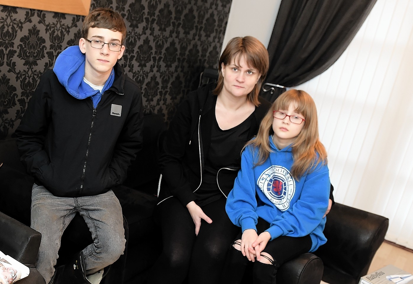 Sarah Leitch with her children Calum and Emma in the living room of their home in Canal View, Port Elphinstone. Picture by Kami Thomson