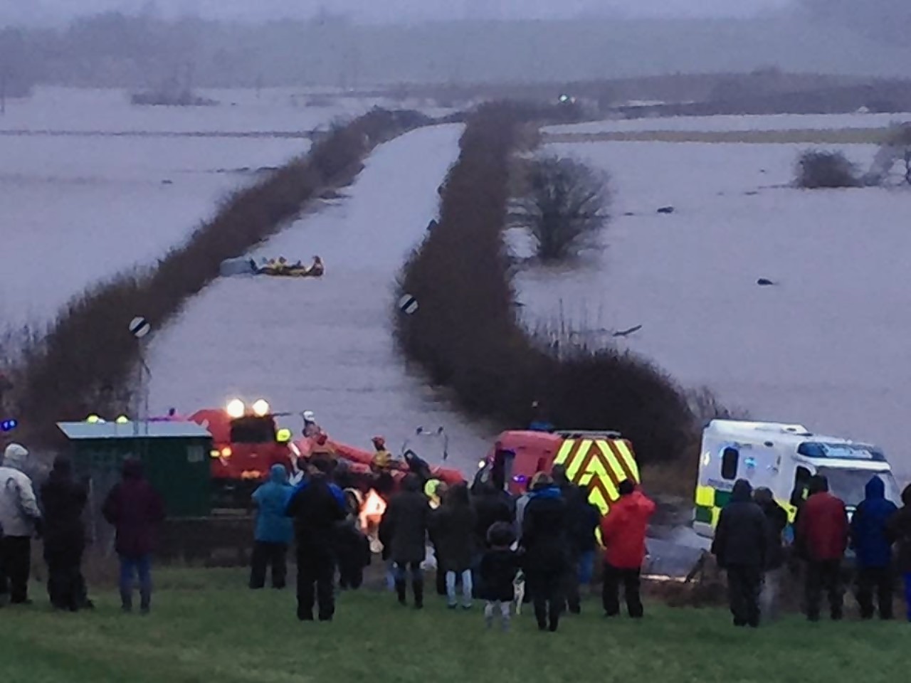 Emergency services rescue a motorist who tried driving through the flooding in Couper Angus