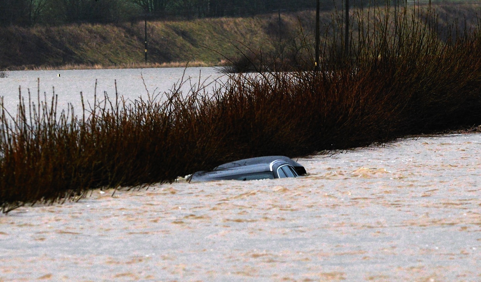 A car is engulfed by the rising water 