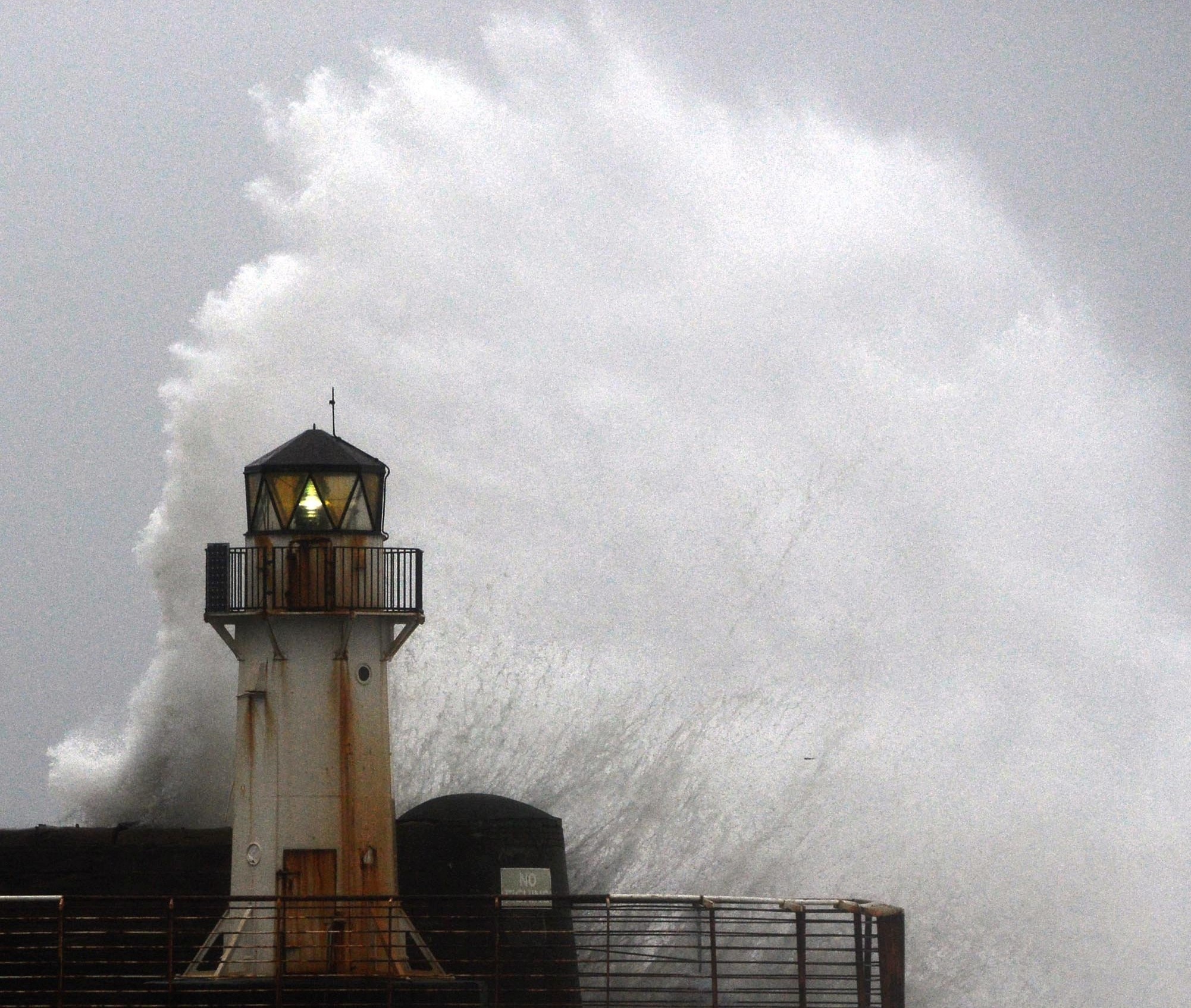 Waves crash into the harbour wall in Ardrossan, Ayrshire, where ferry services to the Isle of Arran have been cancelled until further notice, as the remnants of Storm Jonas batter Scotland.