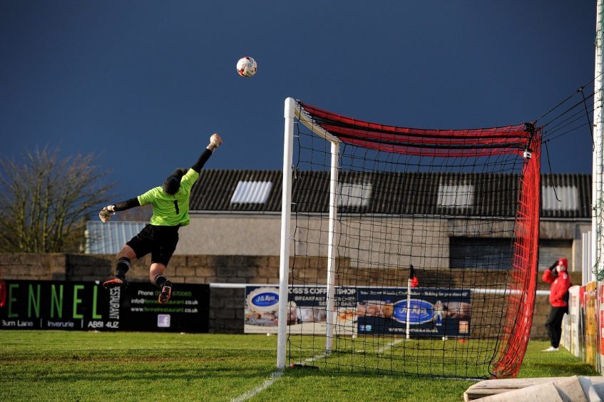 Rothes keeper Matthew Mackie makes an impressive save from a Locos free kick