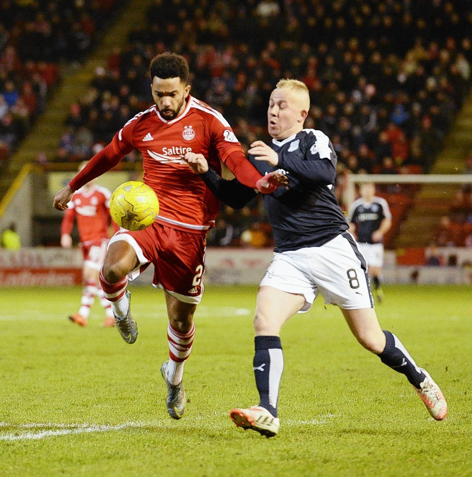 Nicky Low challenges former Dons team mate Shay Logan