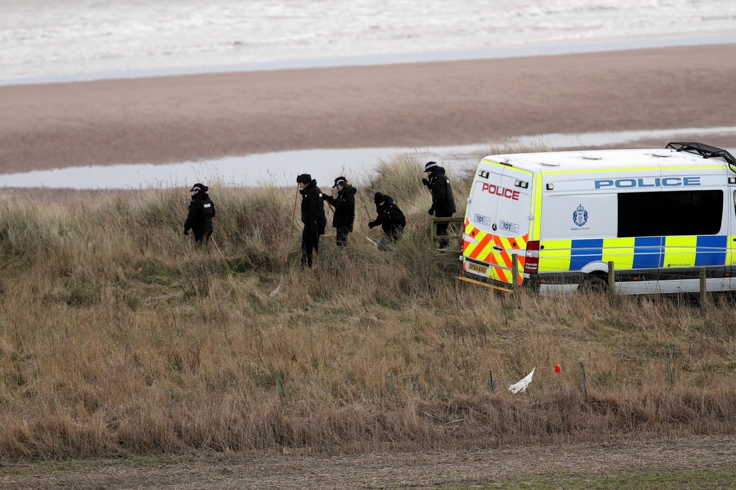 Police search the beach at Lunan Bay 