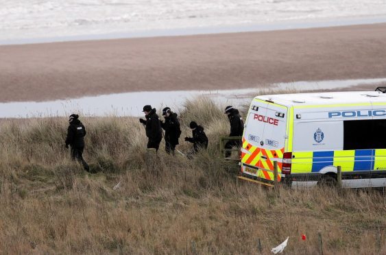 Police search the beach at Lunan Bay