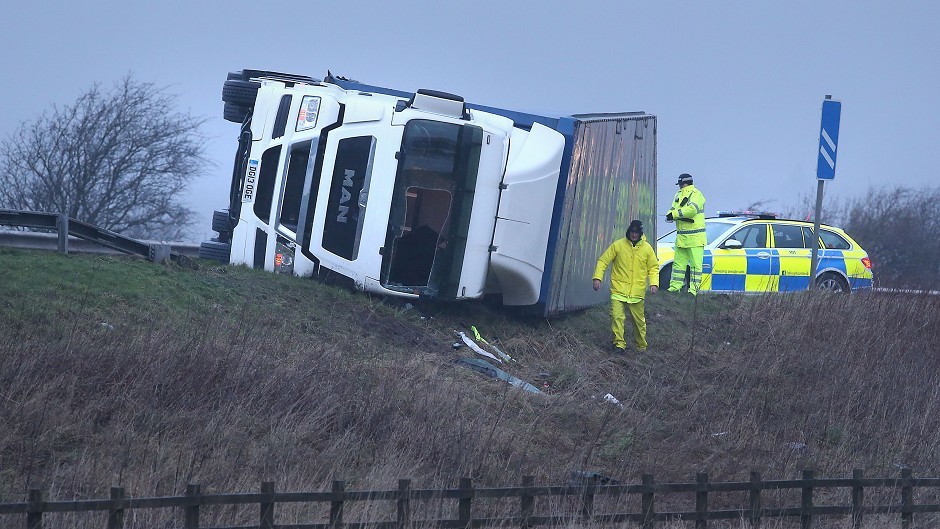 Police at the scene of an overturned lorry on the M9 near Falkirk