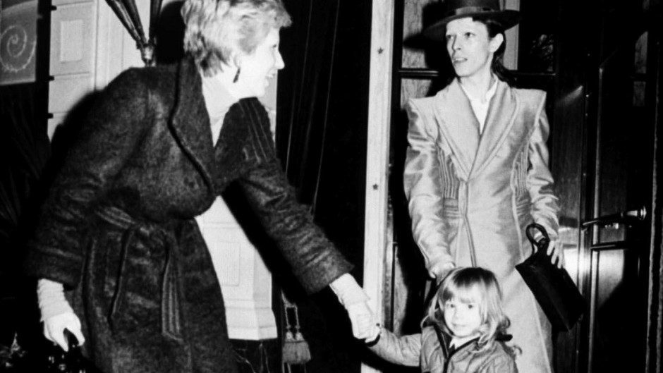 Black and white image of David Bowie with his then-wife Angie and their son Zowie - now Duncan Jones.