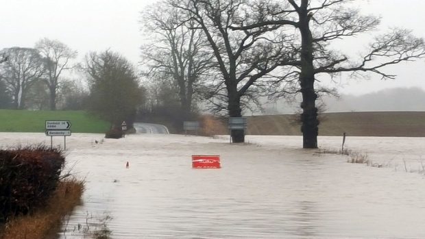 The closed A923 Blairgowrie to Coupar Angus road in Perthshire as communities were warned that more heavy rain across the UK could lead to further flooding