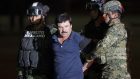 Joaquin "El Chapo" Guzman is escorted to a helicopter in handcuffs by Mexican soldiers and marines (AP)