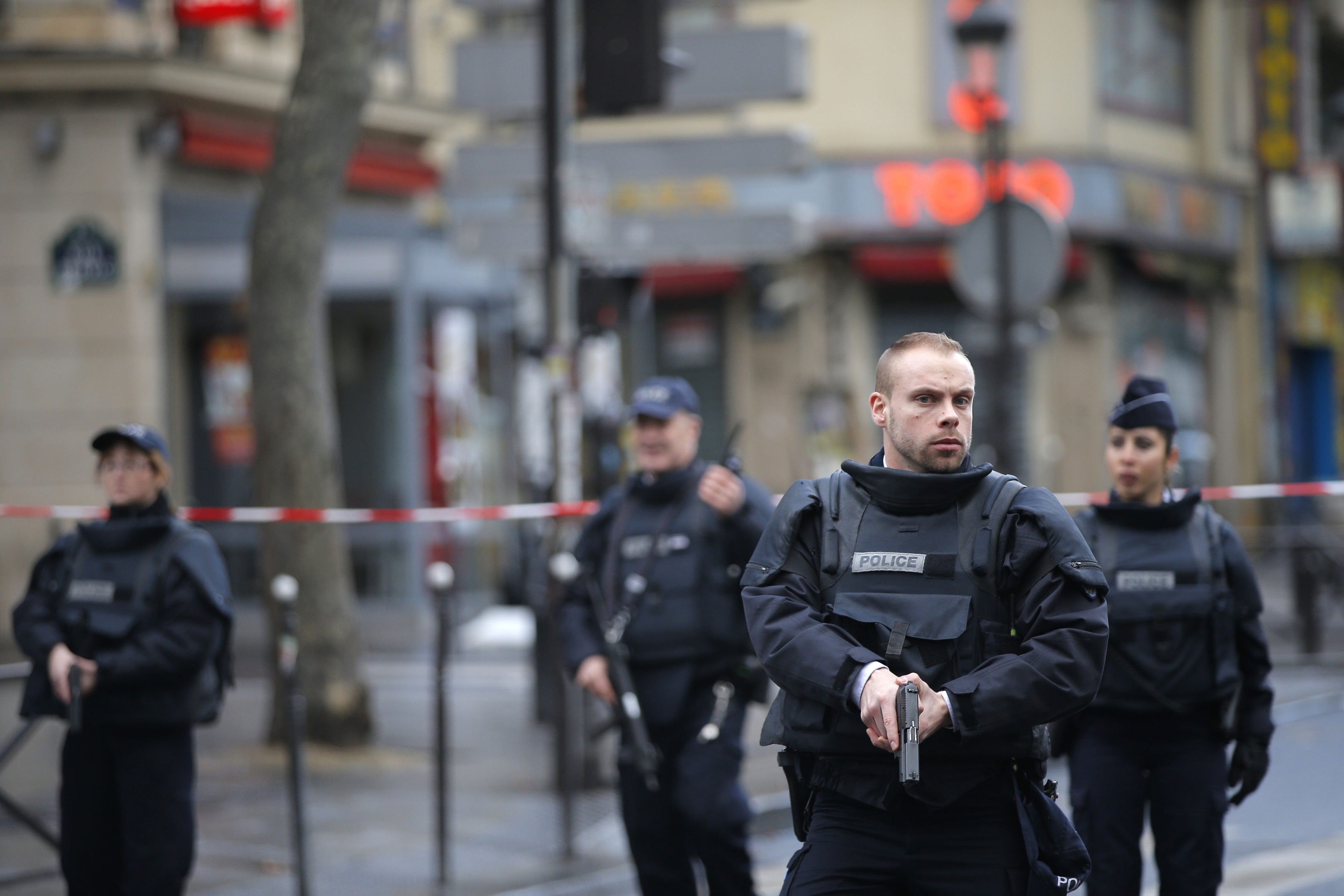 French officials say a man armed with a knife was shot to death by officers at a police station in northern Paris. 