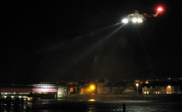 Emergency services, including coastguard helicopter, police, ambulance and the North Kessock Lifeboat search the River Ness after Marek Michalak fell