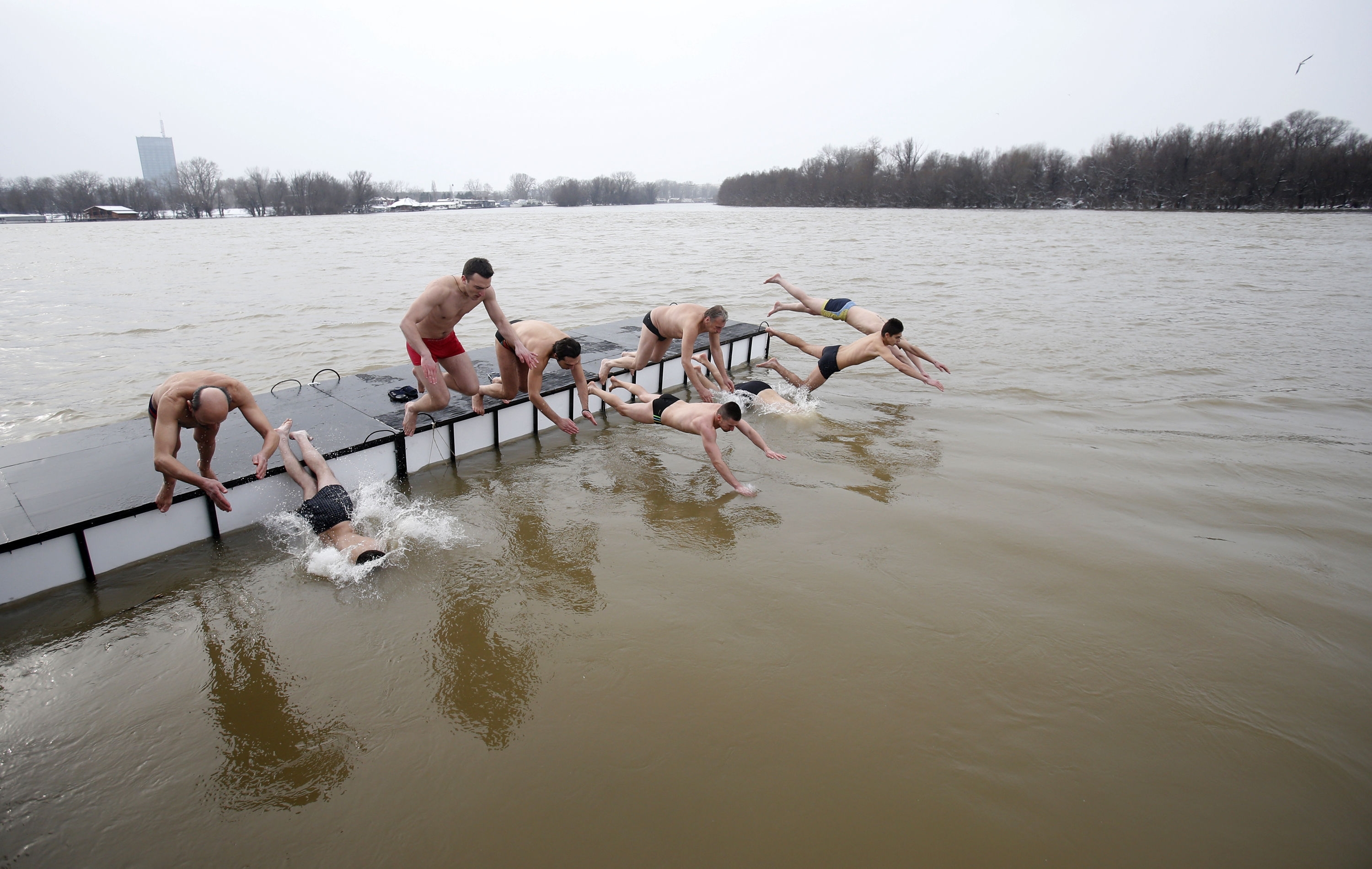 Orthodox believers jump in the icy water of the Sava river in Belgrade, Serbia, Monday, Jan. 18, 2016. Serbian Orthodox Church followers plunged into icy rivers and ponds across the country to mark the upcoming Epiphany, cleansing themselves with water deemed holy for the day. Water that is blessed by a cleric on Epiphany is considered holy and pure until next year's celebration, and is believed to have special powers of protection and healing. (AP Photo/Darko Vojinovic)