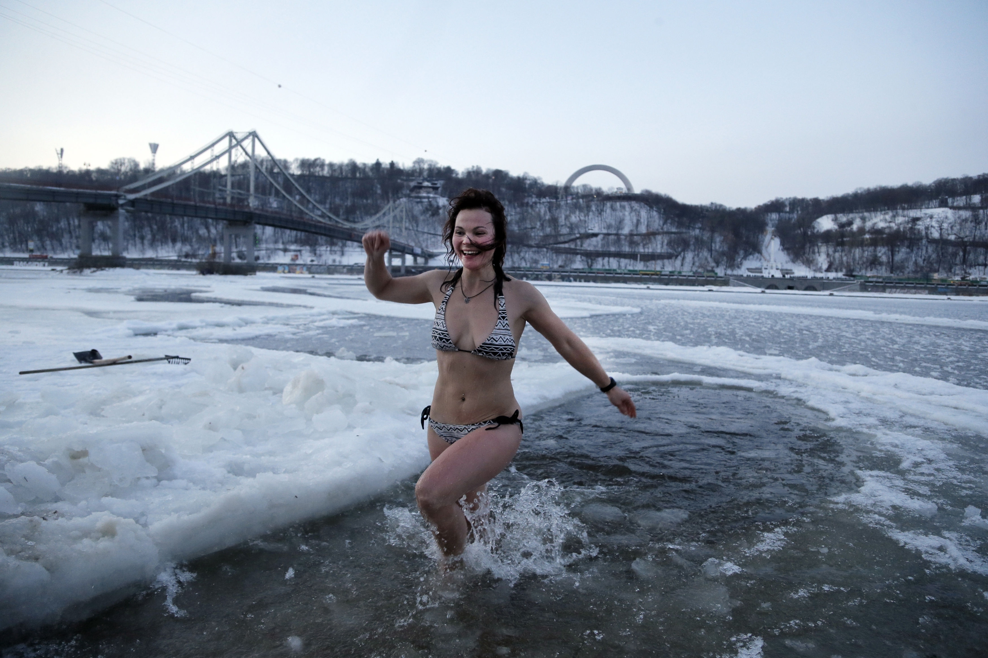 An Orthodox believer plunges in icy water in the Dnipro River during celebrations of the Epiphany in Kiev, Ukraine, Tuesday, Jan. 19, 2016. Orthodox believers celebrate the holiday of the Epiphany on Jan. 19, and traditionally bathe in holes cut through thick ice on rivers and ponds to cleanse themselves with water deemed holy for the day. (AP Photo/Efrem Lukatsky)