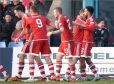 The Dons celebrate JShay Logan's first goal