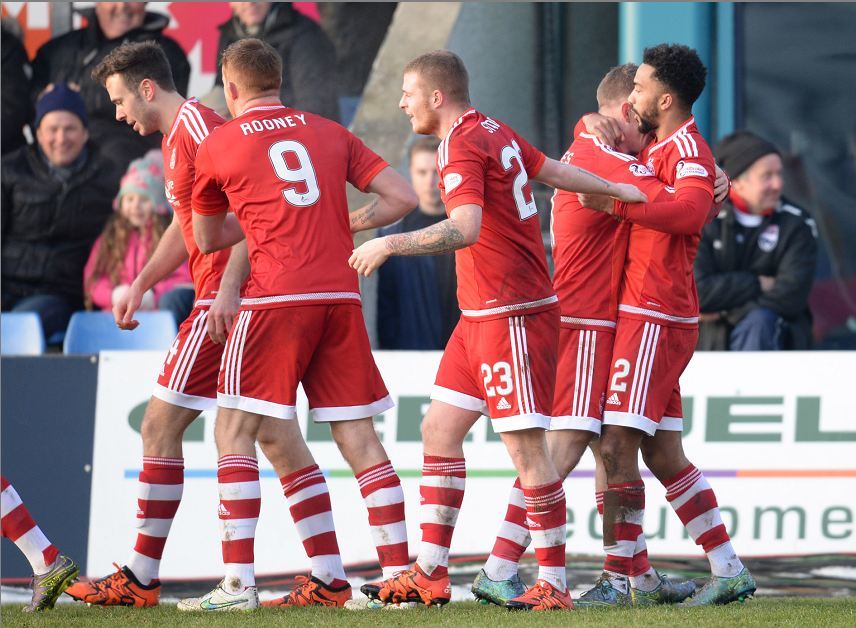The Dons celebrate Jamie Reckord's own goal 