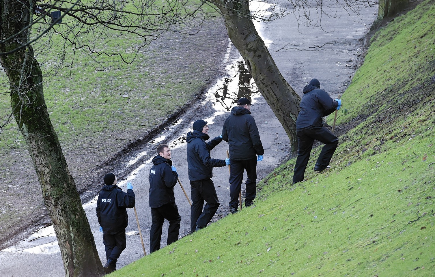 Police officers search Union Terrace Gardens after a woman was raped in January 