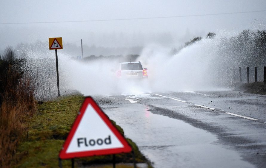 Car drives through flooding