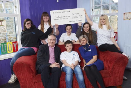 Elgin Youth Cafe Cheque Presentation,
Names LtoR
1&2 (Back row) Chloe Jamieson, Emily Burns, Liam Hughes, Sarah Fiske (Youth Worker) and Adele Starr.
        (Front row) Richard Lochead MSP, Aiden Henderson and Naomi Smith (Bank of Scotland)