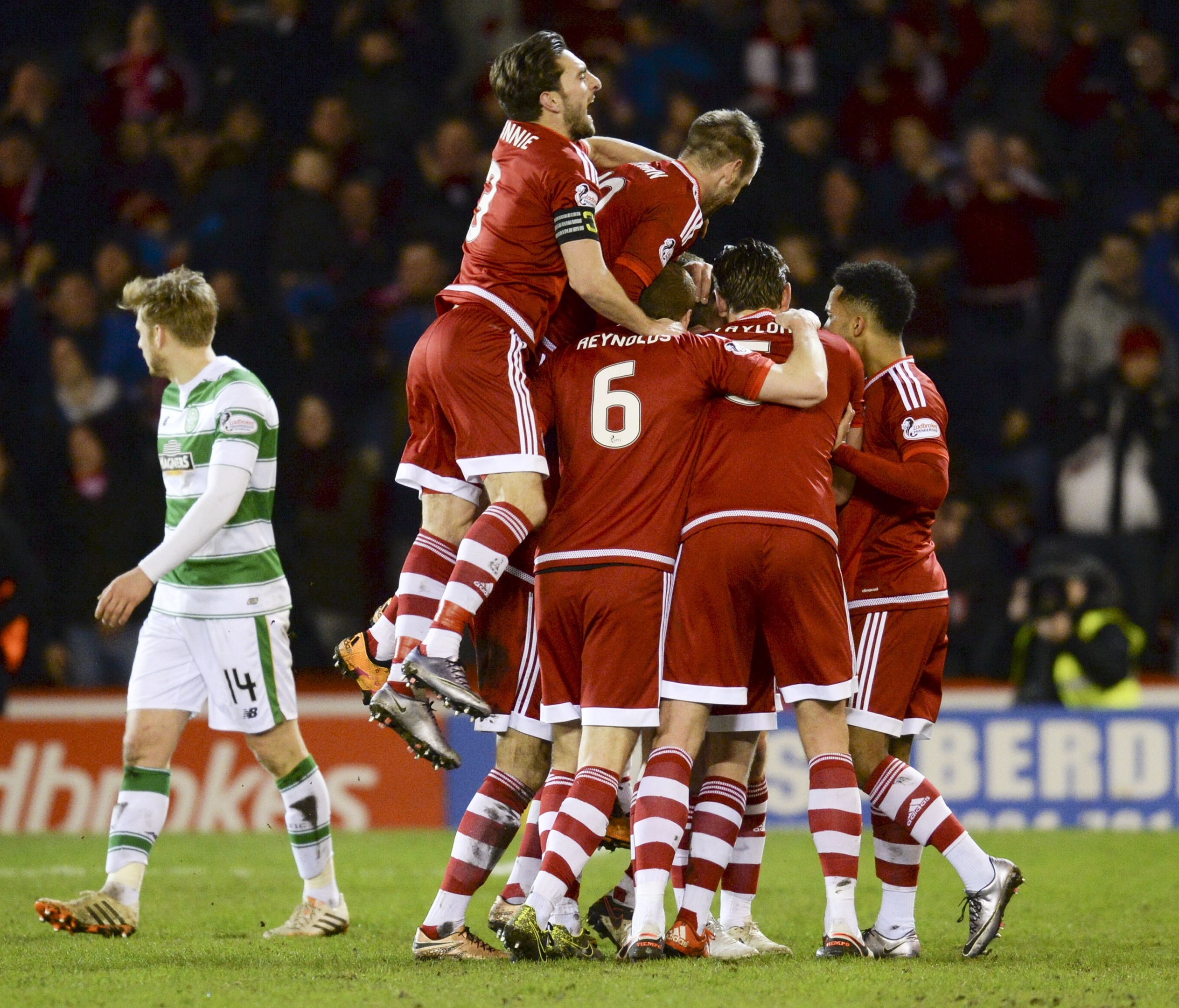 The Aberdeen players congratulate Jonny Hayes (hidden) on his goal