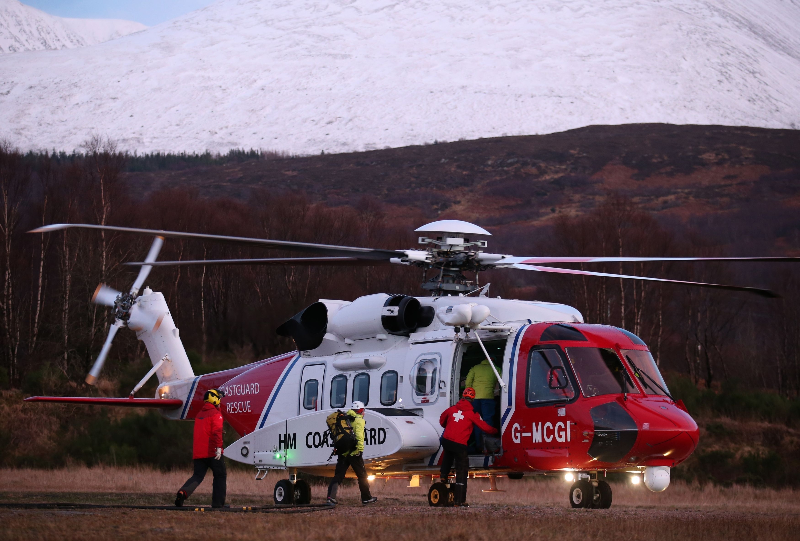 Members of the Lochaber Mountain Rescue team board a search and rescue helicopter after an avalanche