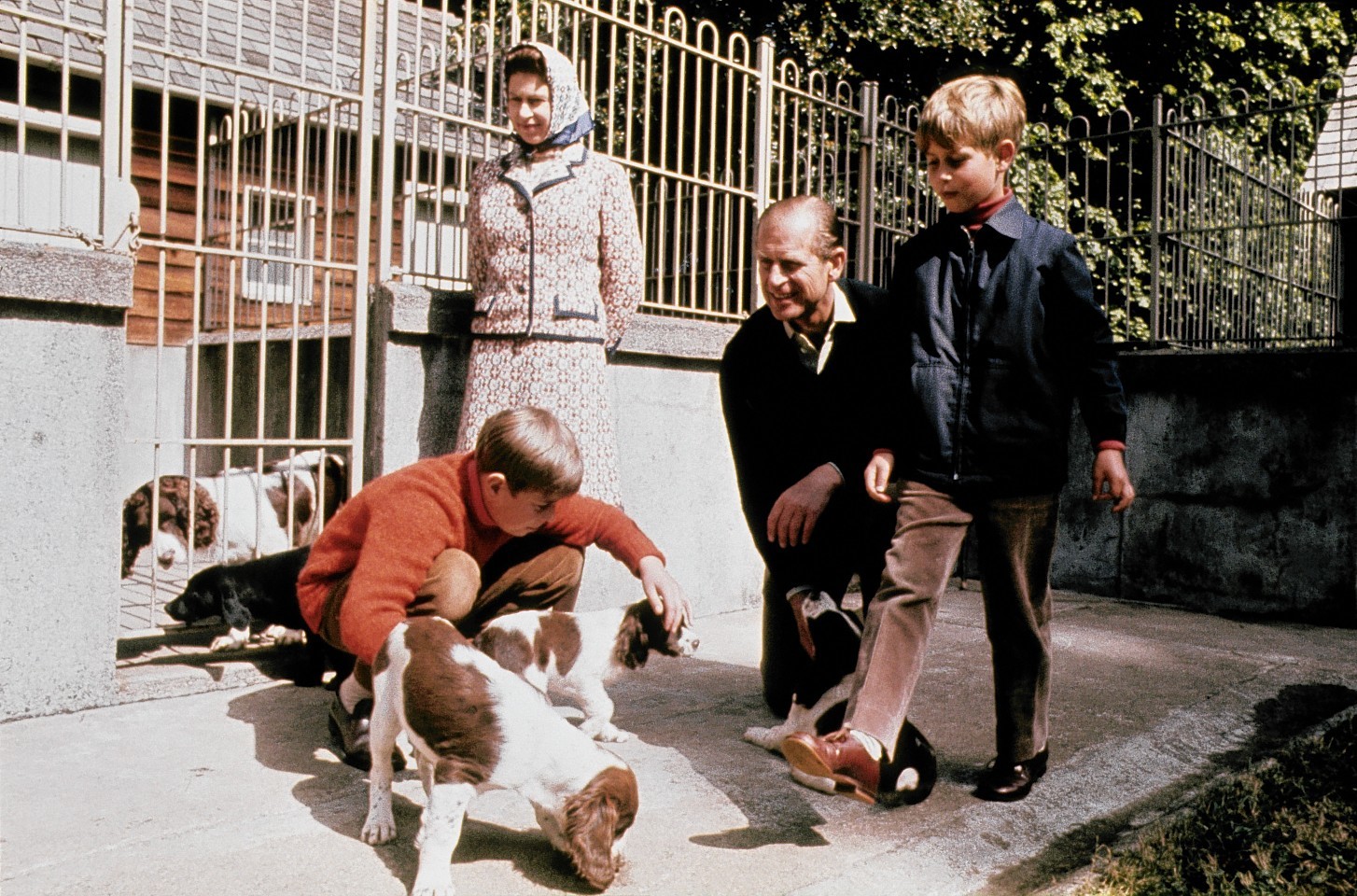 The Queen, Duke of Edinburgh and their two sons Prince Andrew (red sweater) and Prince Edward visit the kennels at Balmoral