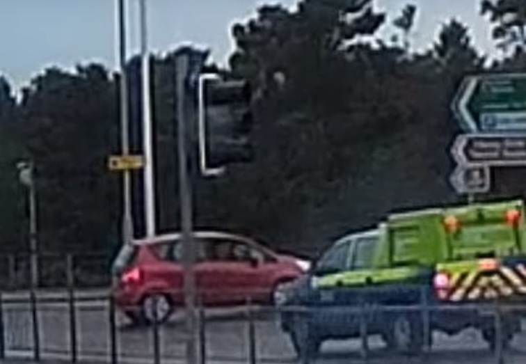 Car reversing on roundabout