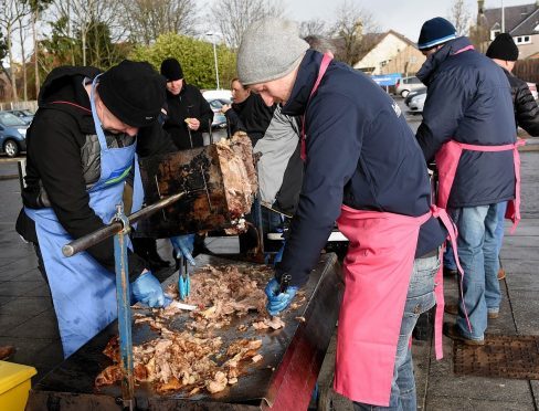 Stephen Forbes (left) and Gus Forbes carving up the meat at Aldi in Inverness.