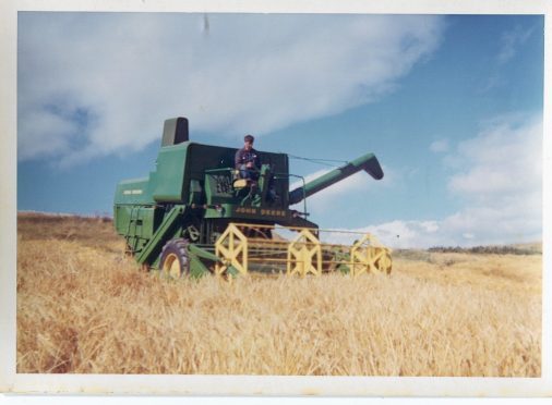 A John Deere 530 combine at work in the 1960s