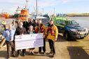 Shepd’s team presenting a cheque for £10,000 at the RNLI’s Aberdeen Lifeboat Station
