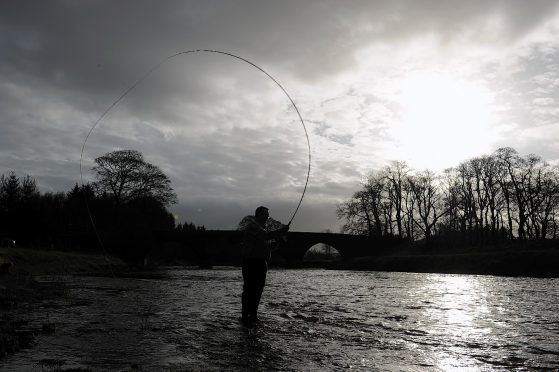 Craig Wyness throws the first line into the River Deveron.