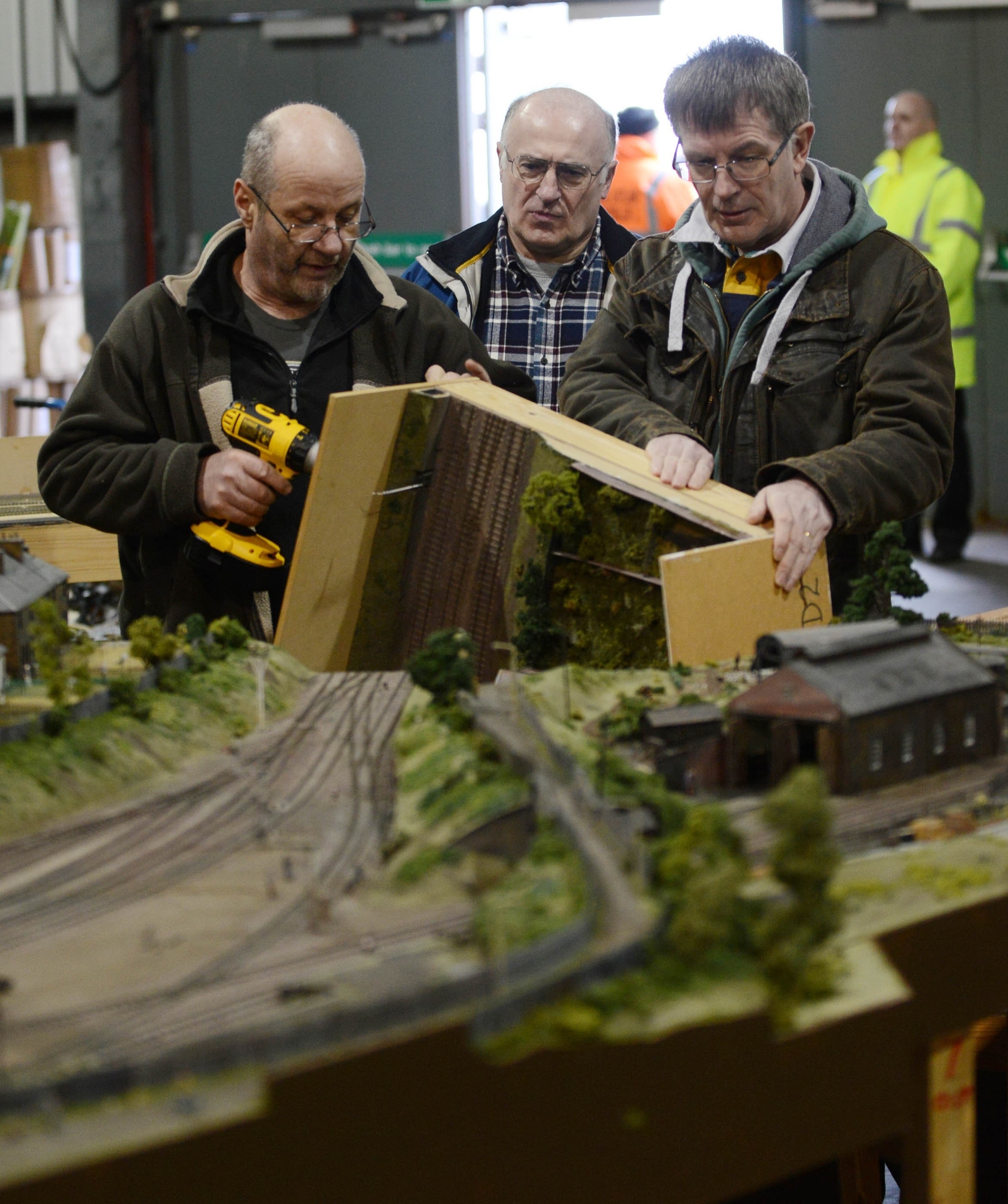 Members get layout ready, a model of the Old Railway Station in Alloa, ahead of the 50th annual gathering of model railway enthusiasts displaying at Glasgow's SECC from tomorrow, Friday 26th to Sunday 28th Febuary, where 30 different clubs from across the UK and further are expected to display. See Centre Press story CPRAIL; Thousands of model railway enthusiasts gather for convention.