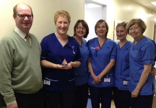 Nurses at Raigmore receive NHS Highland High Quality Award from Gary Coutts, chair of NHS Highland