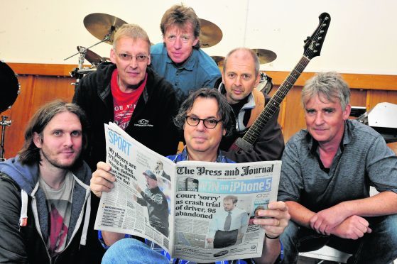 7Aug13.  Balloch, Inverness-shire.  Runrig chat to The Press & Journal before their 40th anniversary gig on the Black Isle.  Pictured from left, Brian Hurren, Iain Bayne, Rory Macdonald, Bruce Guthro (holding paper), Malcolm Jones and Calum Macdonald.
.
Picture by David Whittaker-Smith.          .07/08/13
